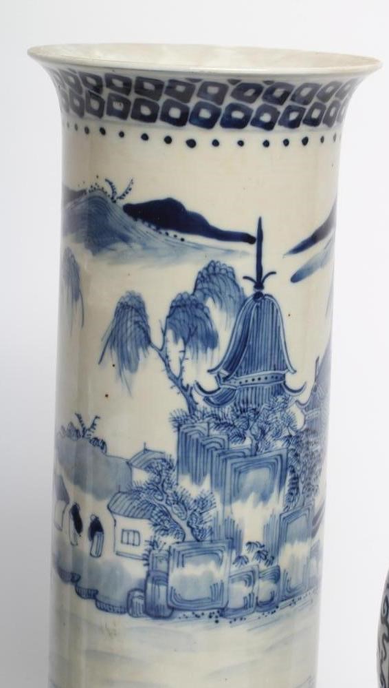 A PAIR OF CHINESE PORCELAIN GU VASES painted in underglaze blue with prunus on a dark shaded ground Image