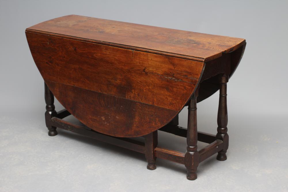 AN OAK DROP LEAF TABLE Image