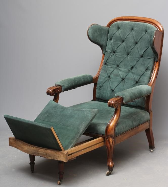 A WILLIAM IV MAHOGANY RECLINING LIBRARY WING ARMCHAIR with pull out leg rest Image
