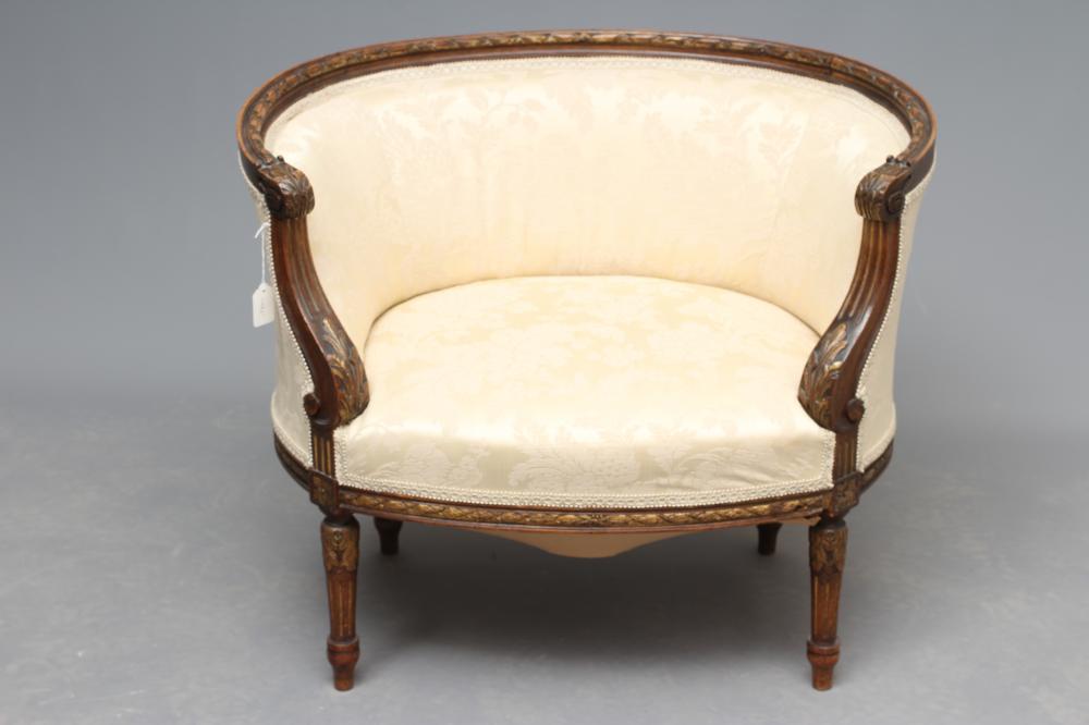 A MAHOGANY AND PARCEL GILT TUB CHAIR in Louis XV style Image