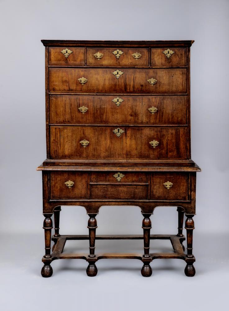 A GEORGIAN WALNUT AND BANDED CHEST ON STAND Image