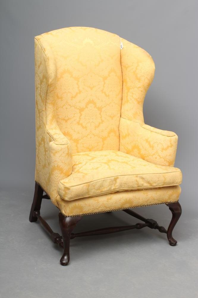 A MAHOGANY FRAMED WING ARMCHAIR Image