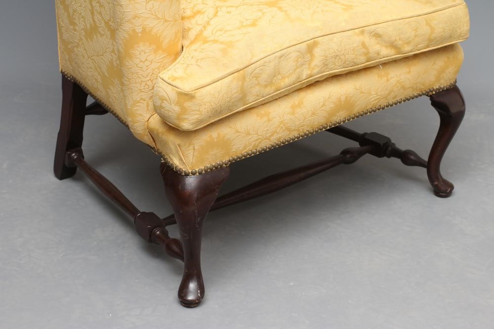 A MAHOGANY FRAMED WING ARMCHAIR Image