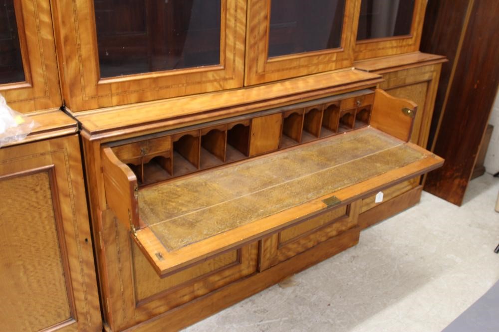 A MID VICTORIAN SATINWOOD BOOKCASE of breakfront form crossbanded with stringing Image