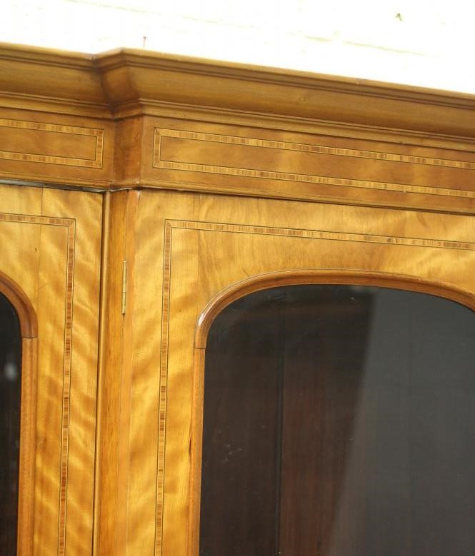 A MID VICTORIAN SATINWOOD BOOKCASE of breakfront form crossbanded with stringing Image