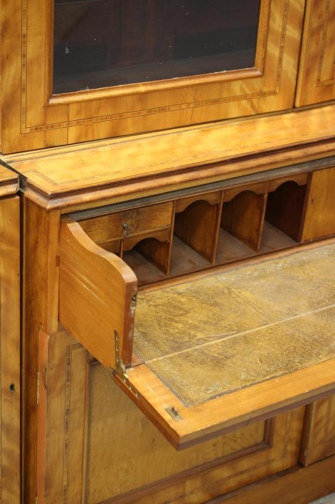 A MID VICTORIAN SATINWOOD BOOKCASE of breakfront form crossbanded with stringing Image