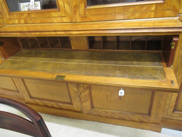 A MID VICTORIAN SATINWOOD BOOKCASE of breakfront form crossbanded with stringing Image