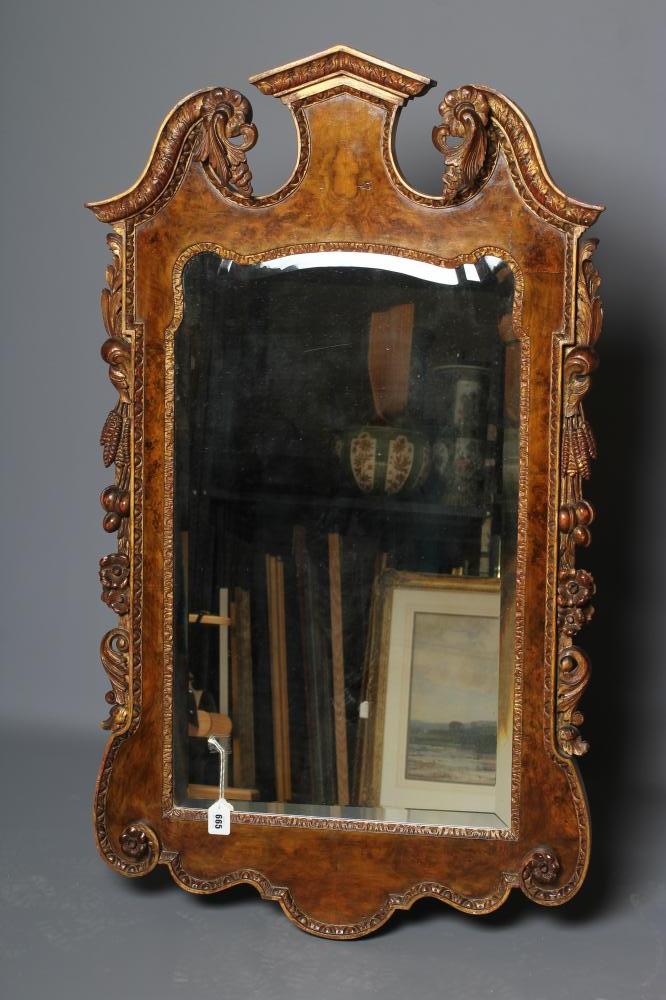 A WALNUT VENEERED AND PARCEL GILT PIER GLASS of early Georgian design Image