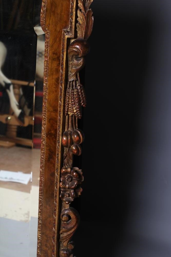 A WALNUT VENEERED AND PARCEL GILT PIER GLASS of early Georgian design Image