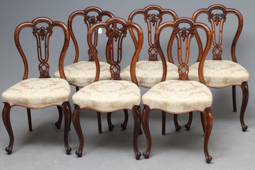 A SET OF SIX VICTORIAN ROSEWOOD DINING CHAIRS of balloon back form upholstered in cream silk damask Image
