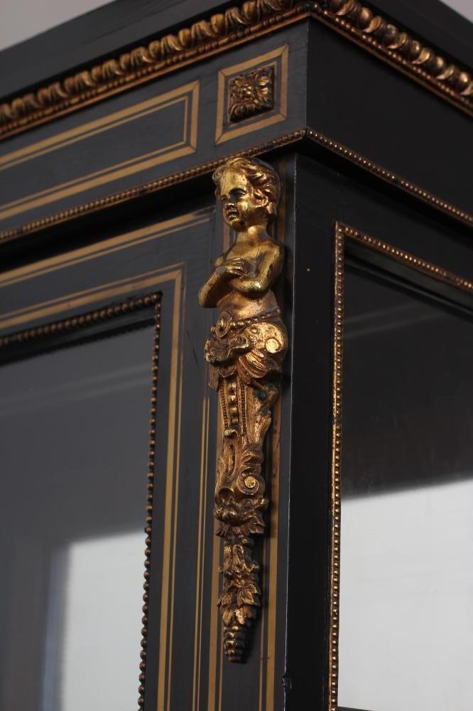 A VICTORIAN EBONISED AND BRASS INLAID PIER DISPLAY CABINET with gilt metal mounts and inset blue Image
