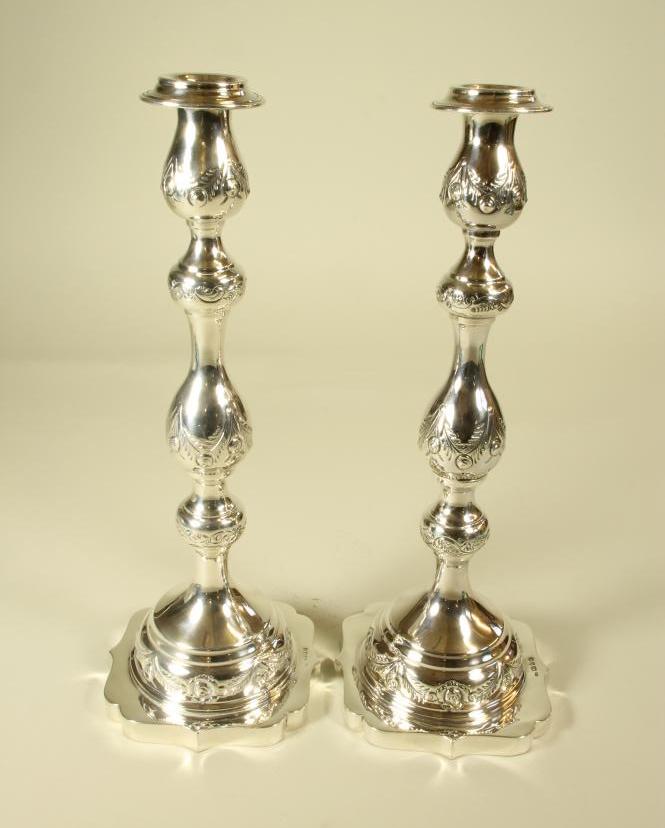 A COMPOSITE PAIR OF SILVER CANDLESTICKS Image