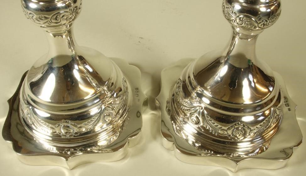 A COMPOSITE PAIR OF SILVER CANDLESTICKS Image
