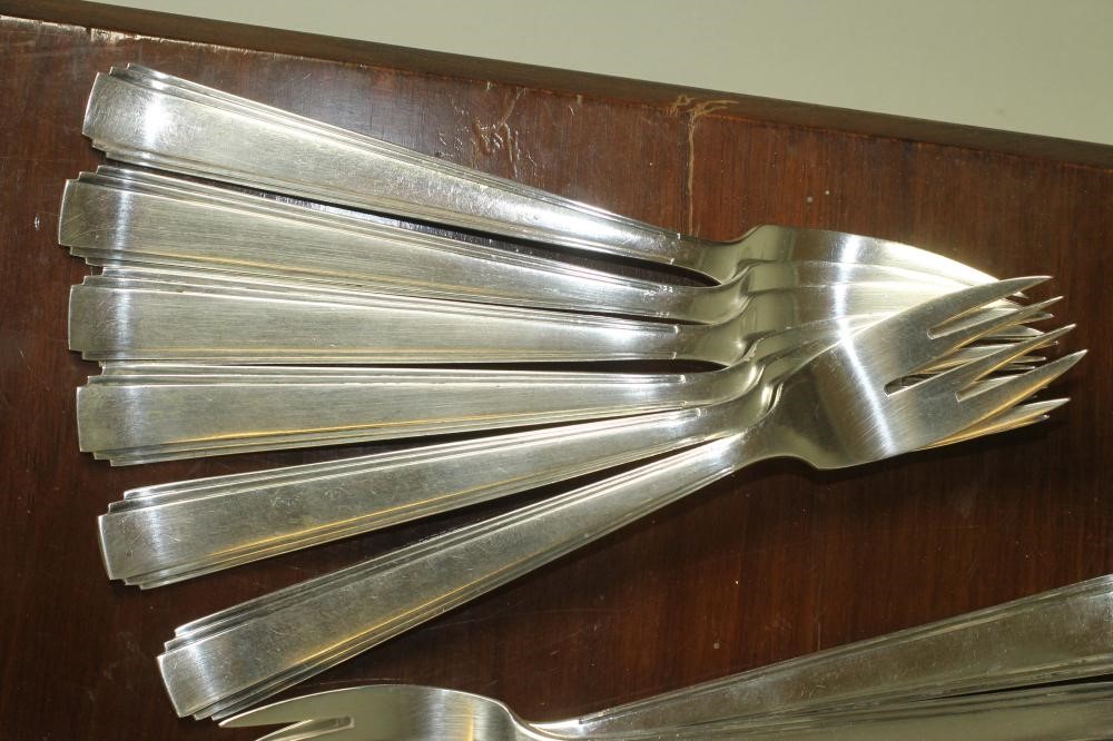 A SET OF TWELVE PAIRS OF ART DECO SILVER FISH KNIVES AND FORKS Image