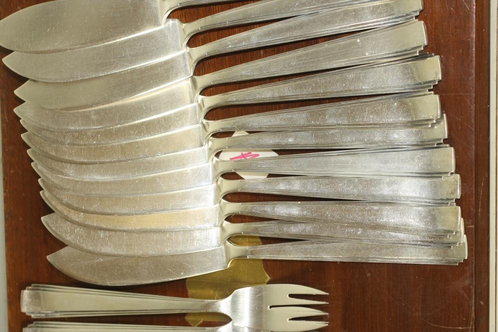 A SET OF TWELVE PAIRS OF ART DECO SILVER FISH KNIVES AND FORKS Image