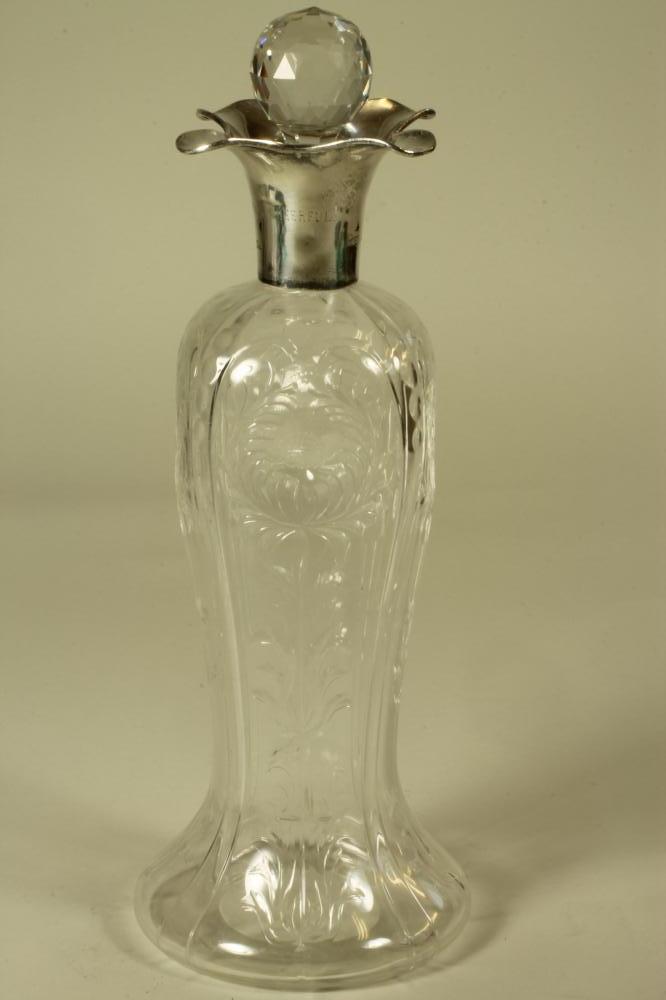 A SILVER MOUNTED STEVENS AND WILLIAMS STYLE CLEAR GLASS DECANTER Image