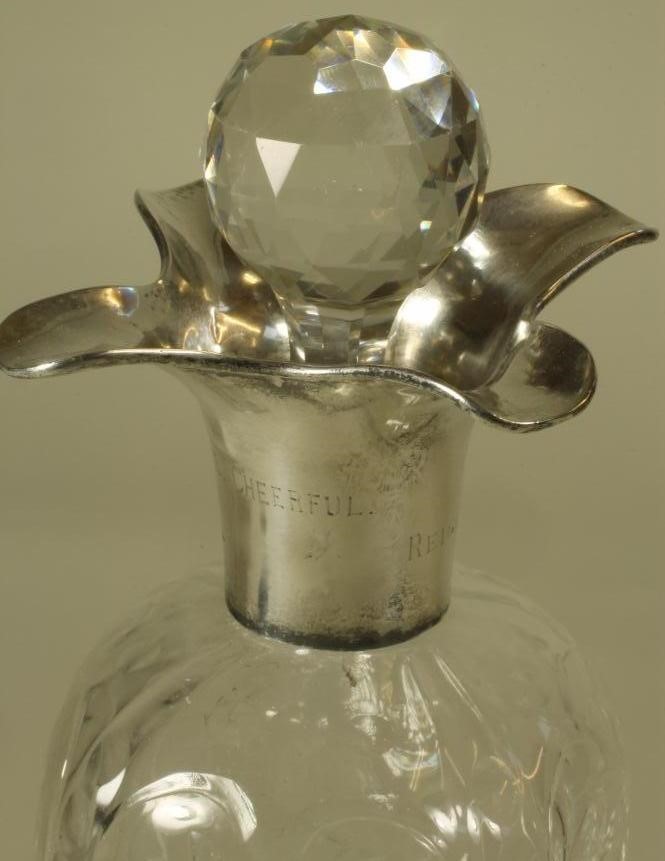 A SILVER MOUNTED STEVENS AND WILLIAMS STYLE CLEAR GLASS DECANTER Image