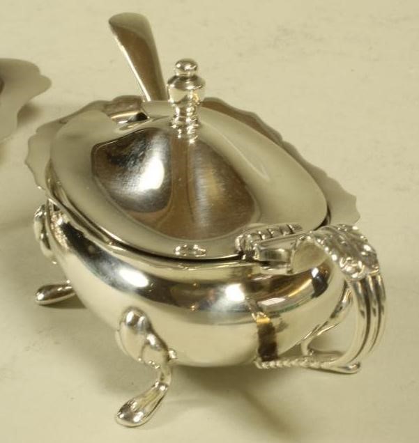 A SILVER THREE PIECE CRUET ON TRAY Image