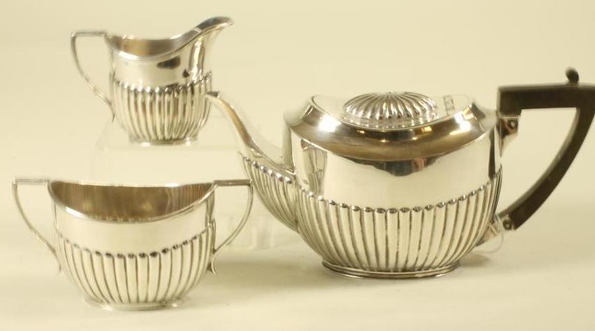 A BACHELOR'S EDWARDIAN SCOTTISH SILVER THREE PIECE TEA SERVICE Image