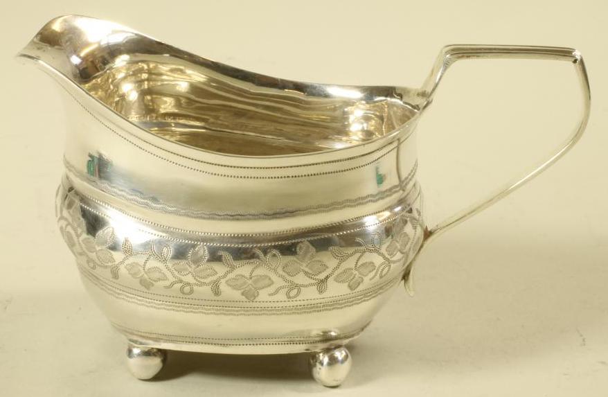 A LATE GEORGE III SILVER MILK JUG Image