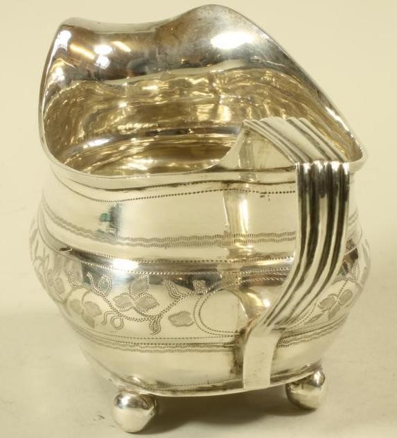 A LATE GEORGE III SILVER MILK JUG Image