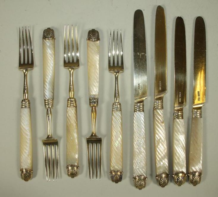 A PART SET OF LATE GEORGE III SILVER GILT DESSERT KNIVES AND FORKS Image