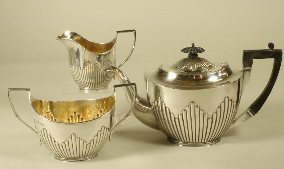 A COMPOSITE EDWARDIAN SILVER THREE PIECE TEA SERVICE Image