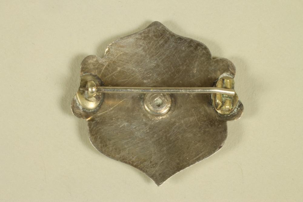 AN EDWARDIAN ARTS AND CRAFTS SILVER AND ENAMEL BROOCH Image