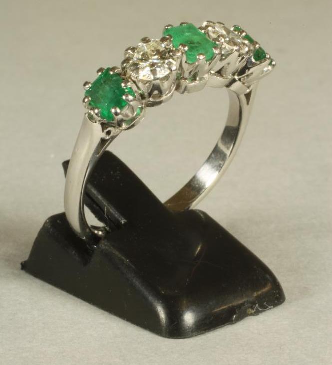 AN EMERALD AND DIAMOND FIVE STONE RING Image