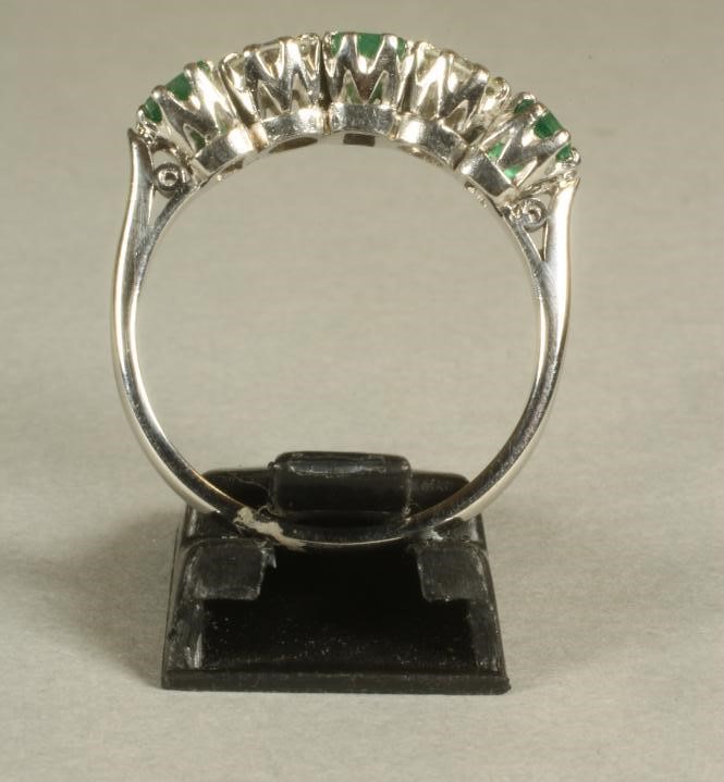 AN EMERALD AND DIAMOND FIVE STONE RING Image