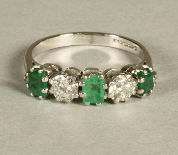 AN EMERALD AND DIAMOND FIVE STONE RING Image