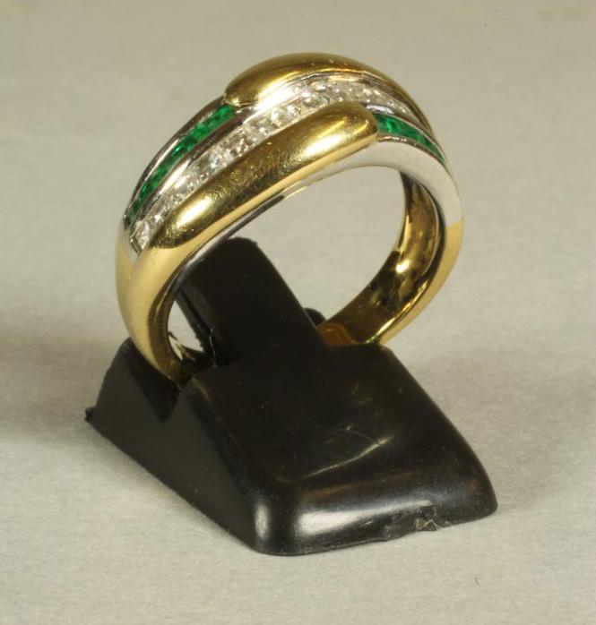 AN EMERALD AND DIAMOND FANCY HALF HOOP RING centred by a wavy band of channel set baguette cut Image