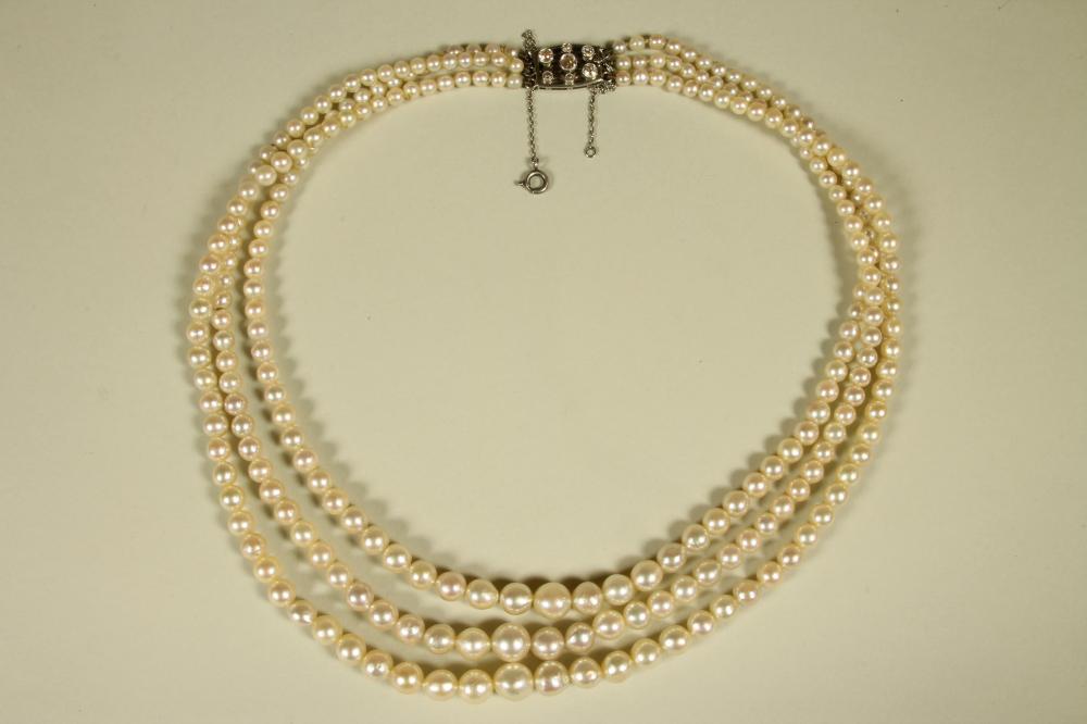 A GRADUATED TRIPLE STRAND CULTURED PEARL NECKLACE Image