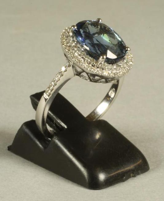 A TANZANITE AND DIAMOND CLUSTER RING Image