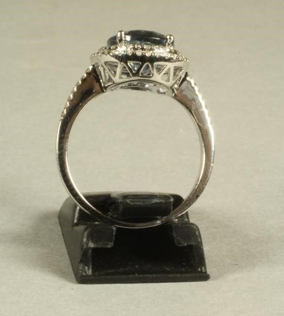 A TANZANITE AND DIAMOND CLUSTER RING Image