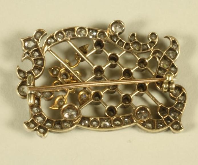 AN EDWARDIAN DIAMOND SET OPEN TRELLIS WORK PANEL BROOCH of rococo form Image