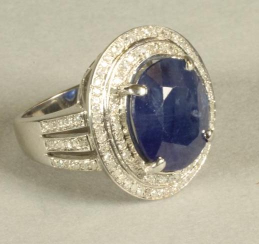 A SAPPHIRE AND DIAMOND CLUSTER RING Image