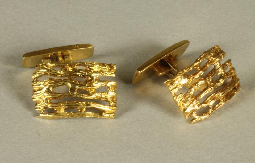 A PAIR OF ANDREW GRIMA STYLE 18CT GOLD CUFFLINKS of cast and pierced asymmetric oblong form with a Image