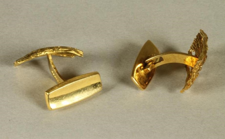 A PAIR OF ANDREW GRIMA STYLE 18CT GOLD CUFFLINKS of cast and pierced asymmetric oblong form with a Image