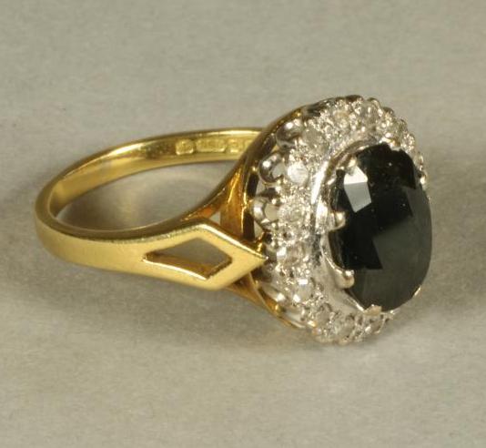 A SAPPHIRE AND DIAMOND CLUSTER RING Image