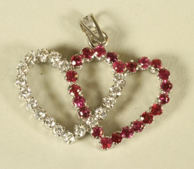 A RUBY AND DIAMOND ENTWINED HEART PENDANT Image