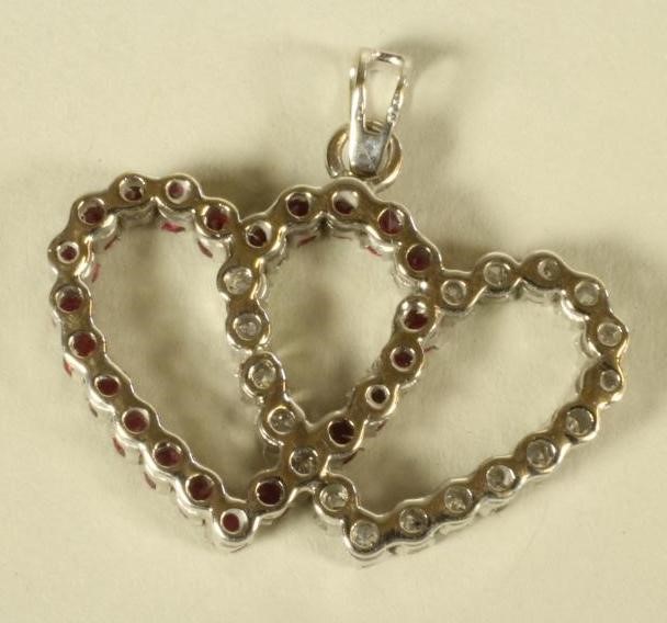 A RUBY AND DIAMOND ENTWINED HEART PENDANT Image