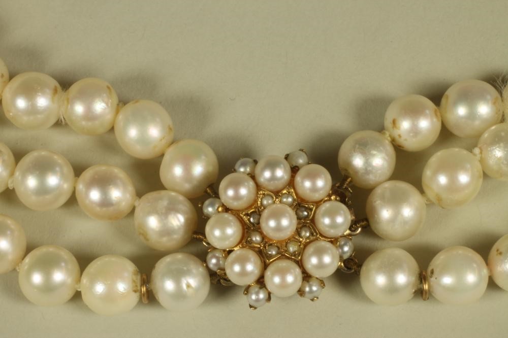 A TRIPLE STRAND CULTURED PEARL NECKLACE Image