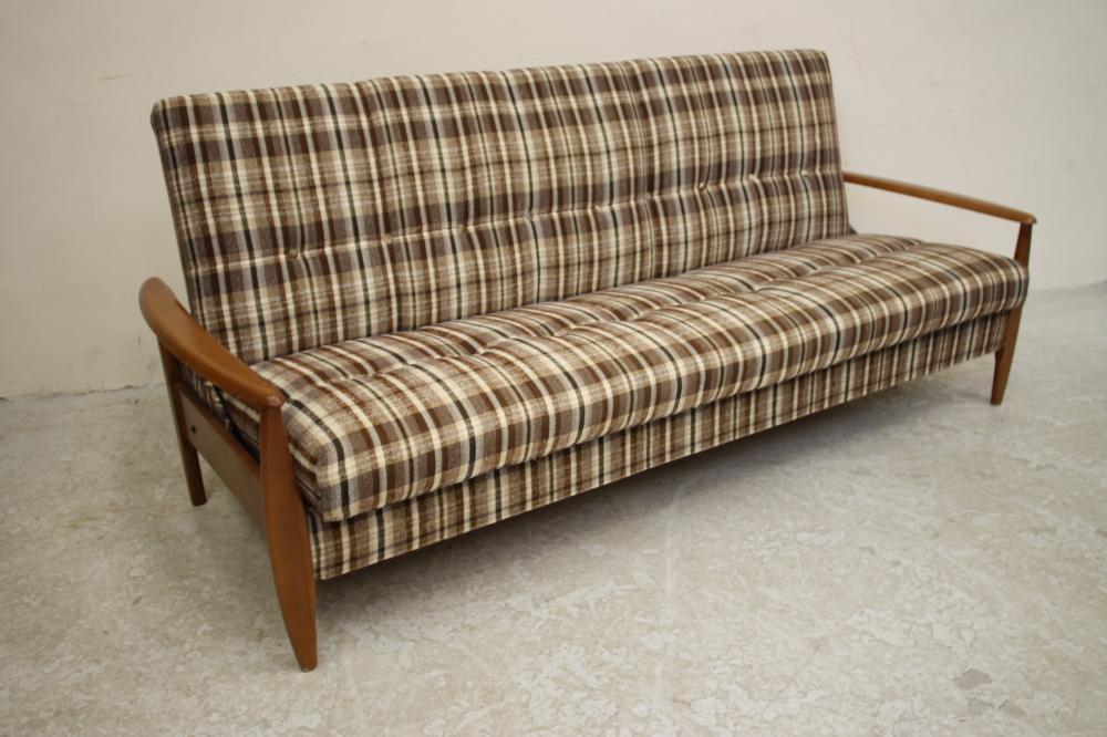 A SCANDINAVIAN DESIGN TEAK FRAMED SOFA BED button upholstered in a black Image