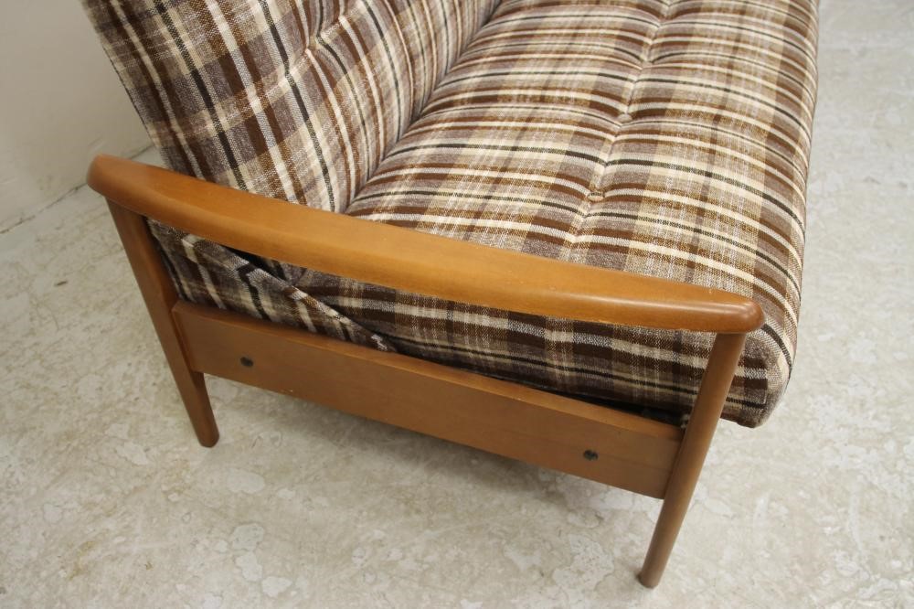 A SCANDINAVIAN DESIGN TEAK FRAMED SOFA BED button upholstered in a black Image