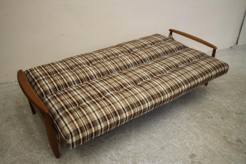 A SCANDINAVIAN DESIGN TEAK FRAMED SOFA BED button upholstered in a black Image