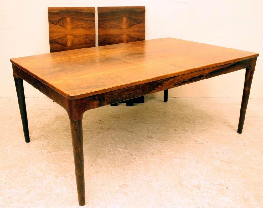 A SCANDINAVIAN DESIGN ROSEWOOD EXTENDING DINING TABLE of rounded oblong form with two separate Image