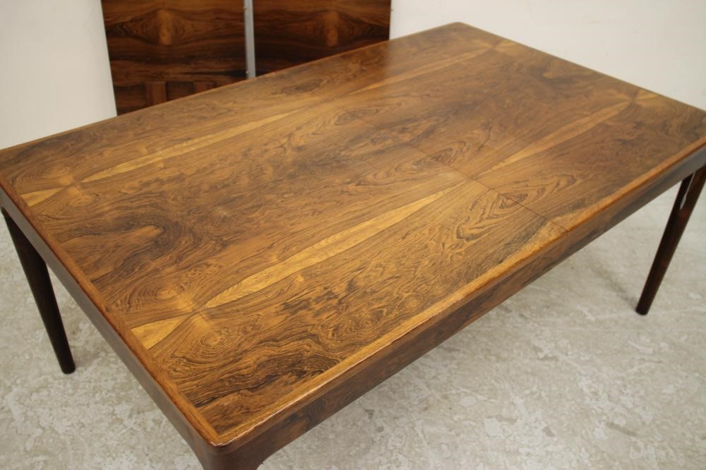 A SCANDINAVIAN DESIGN ROSEWOOD EXTENDING DINING TABLE of rounded oblong form with two separate Image