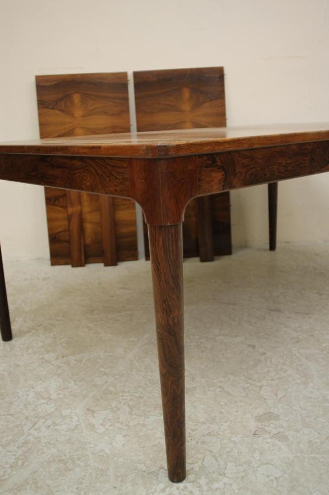 A SCANDINAVIAN DESIGN ROSEWOOD EXTENDING DINING TABLE of rounded oblong form with two separate Image