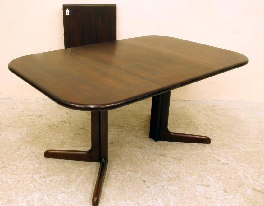 A DANISH ROSEWOOD EXTENDING DINING TABLE Image